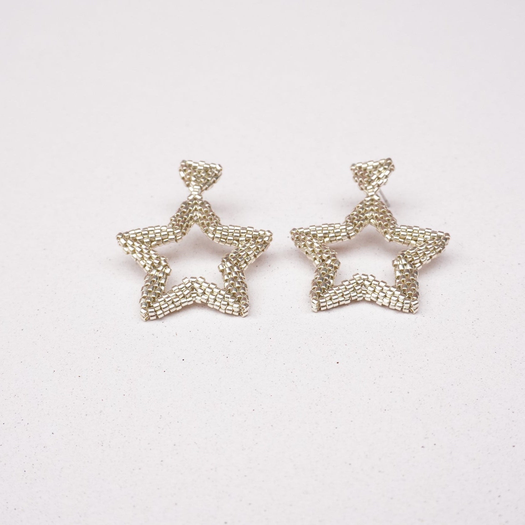 Star-shaped earrings on a white background
